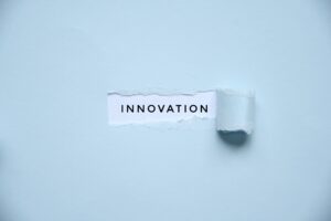 Overhead photo of a light blue paper with a hole where it says innovation